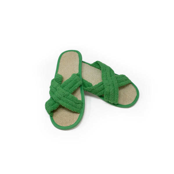 Green loofah slippers on white background