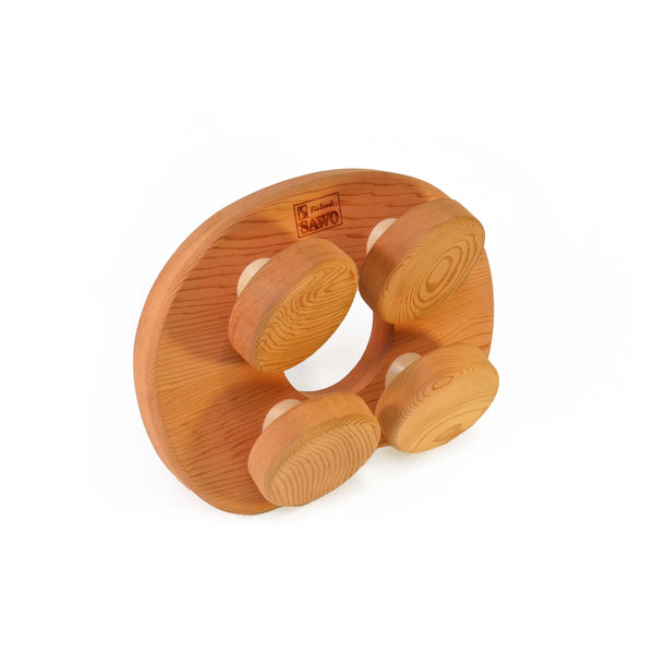 Cedar sauna pillow with four rotating wooden discs on white background.
