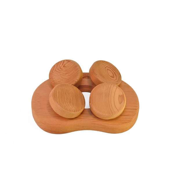 Cedar sauna pillow with four rotating wooden discs on white background.