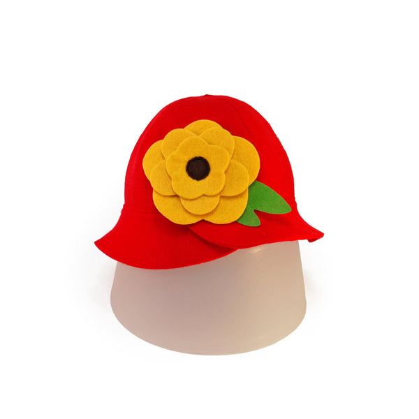 Front view of red wool sauna hat with a big yellow flower on a white background.