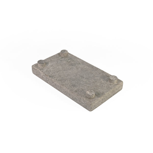 Bottom side of a soapstone soap bar holder on a white background.